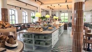 A spacious restaurant with high ceilings, large windows, and a checkered floor. - Quality Hotel The Book (Gothenburg)