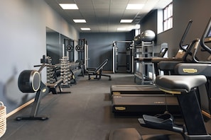 A gym with treadmills, weight machines, and free weights.