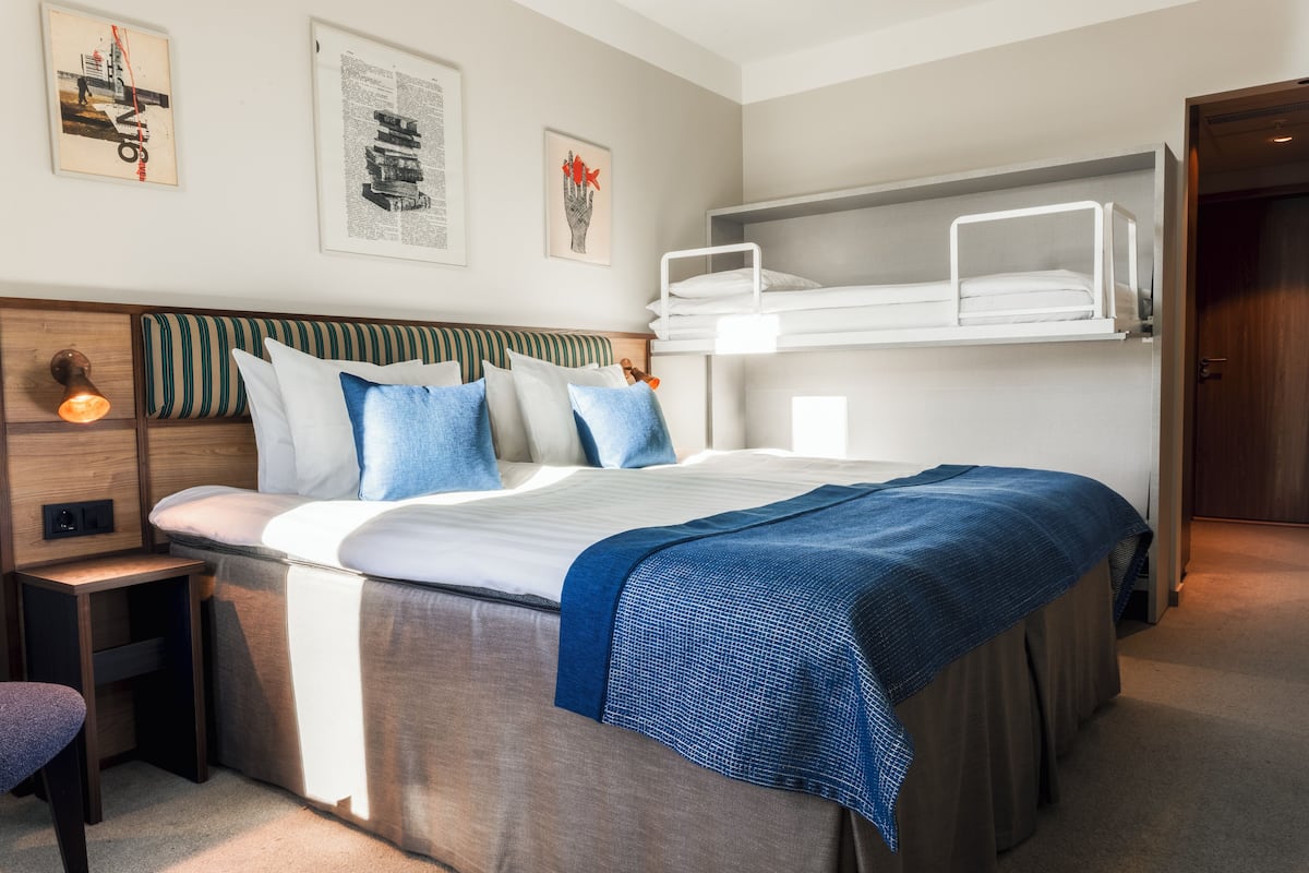 Hypo-allergenic bedding, desk, laptop workspace, blackout drapes