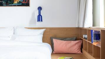 Premium bedding, desk, laptop workspace, soundproofing