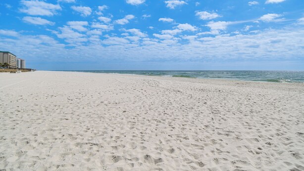 A beach with a building on the left. - Family Friendly & Resort Perks! Perdido Key Condo (Pensacola)