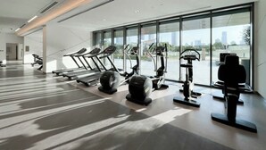 A modern gym with treadmills, elliptical machines, and free weights. - StayShort - 2 Bed in Downtown Dubai that Sleeps 4 with Canal Views! (Downtown)