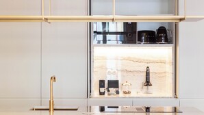 A modern kitchen with a built-in stove, a sink, and a countertop. - Entreparedes House (Porto)