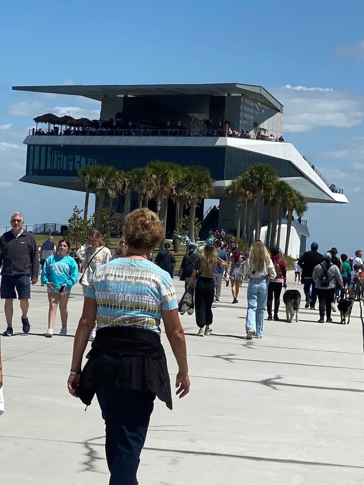 A modern building with a unique architectural design, featuring a curved structure and a flat roof.
