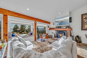 A cozy living room with a fireplace, comfortable seating, and a scenic view. - Lakeview Incline Village Gem | Near Beach & Ski (Incline Village)