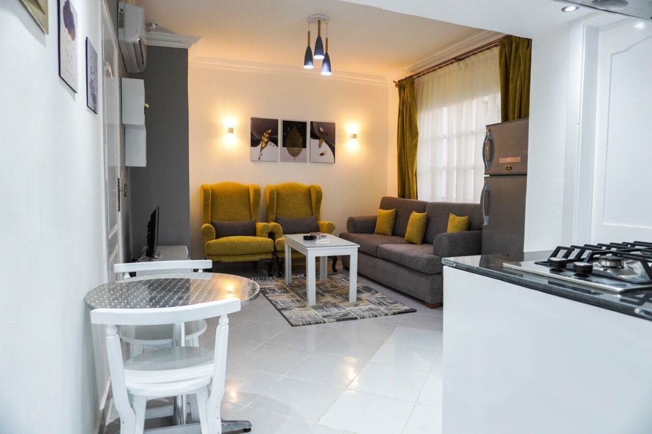 A compact living space with a kitchen, dining area, and seating.