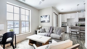 A modern apartment with a living room, dining area, and kitchen. - Landing Apartments near Rivergate Park Area (Cleveland)