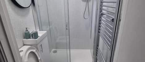 Shower, hair dryer, towels, soap