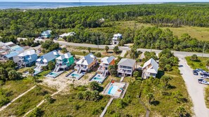 A coastal residential area with multiple houses, a swimming pool, and a beach. - The Turtle's Nest (Port St. Joe)