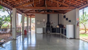 An open-plan kitchen with a tiled floor, a built-in oven, and a refrigerator.