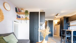 A modern living room with a sofa, a coffee table, and a bookshelf.