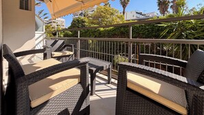 An outdoor patio with wicker furniture and a canopy. - Elegant Living in Glyfada Center (Glifada)