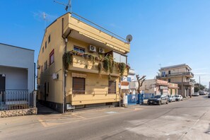 A two-story building with balconies, air conditioning units, and a satellite dish. - Angelina's House Apartment with Balcony and Air Conditioning (Sant'Anna)
