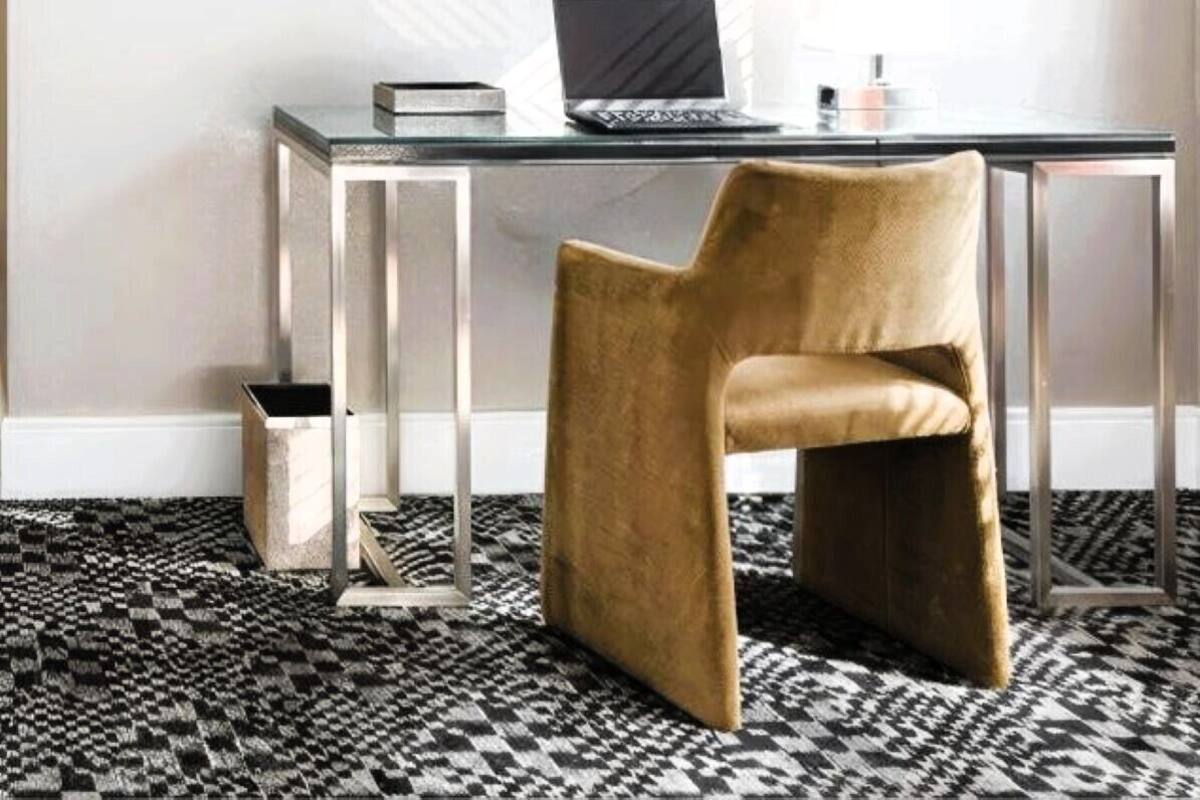 A modern room with a desk, chair, and a flat-screen TV mounted on the wall.