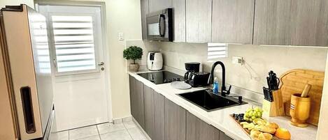 Fridge, microwave, stovetop, coffee/tea maker