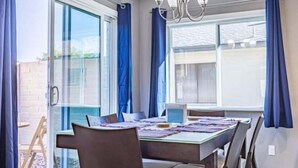 A dining area with a table, chairs, and a chandelier. - Cozy townhouse with community pool, heart of Tempe near ASU (Tempe)
