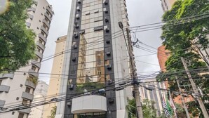Un immeuble moderne et imposant, doté d’une partie supérieure incurvée et de nombreux balcons.
