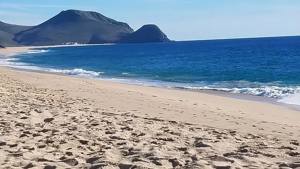 A beach with clear blue water and distant mountains. - Escape Casita – Incredible Ocean Views, A/C & Heated Saltwater Pool (Todos Santos)