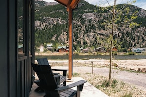 A lakeside view with a wooden deck, a chair, and a view of houses and mountains. - Lakefront | Trails | Skiing | Views | Georgetown (Georgetown)
