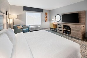 A hotel room with a large bed, a desk, a flat-screen TV, and a window with a view. - Hampton Inn By Hilton Aiken (Aiken)