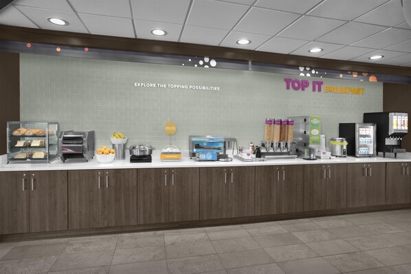 A breakfast counter with a sign that reads 'TOP IT BREAKFAST' and a menu board above it. - Tru By Hilton Midland East (Midland)