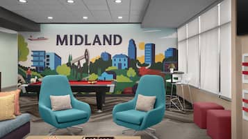 A room with teal chairs, a pool table, a snooker table, and a mural of a cityscape labeled 'MIDLAND'.