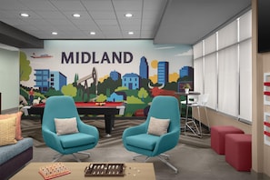 A room with teal chairs, a pool table, a snooker table, and a mural of a cityscape labeled 'MIDLAND'. - Tru By Hilton Midland East (Midland)