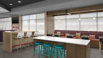 A modern interior with a bar area, seating, and large windows.
