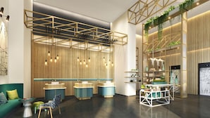 A modern interior with a reception desk, seating area, and a bar. - Hilton Garden Inn Bengaluru Embassy TechVillage Outer Ring Road (Bengaluru)