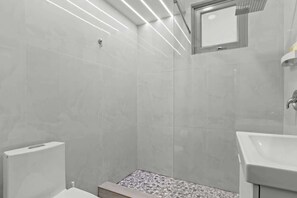 Ein modernes Badezimmer mit Dusche, Toilette und Waschbecken.