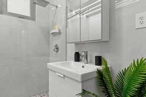 A modern bathroom with a shower, a sink, and a mirror. - Apartment 2Bedroom Next To La Placita Santu 2B (San Juan)