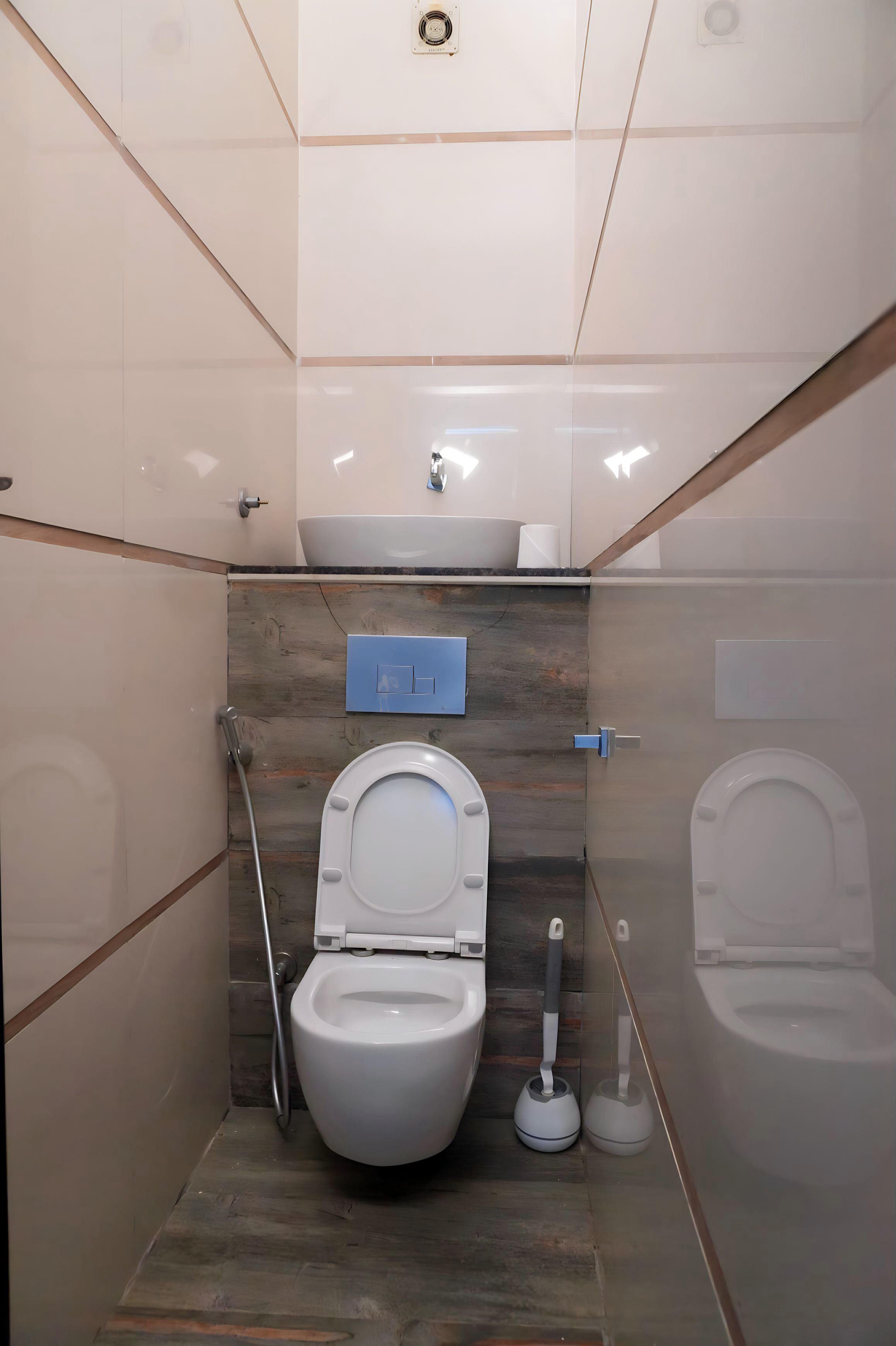 A modern bathroom with a toilet, bidet, and sink.