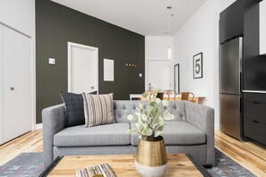 Comfort Apartment | Living area | 65-inch Smart TV with digital channels, Netflix, Hulu