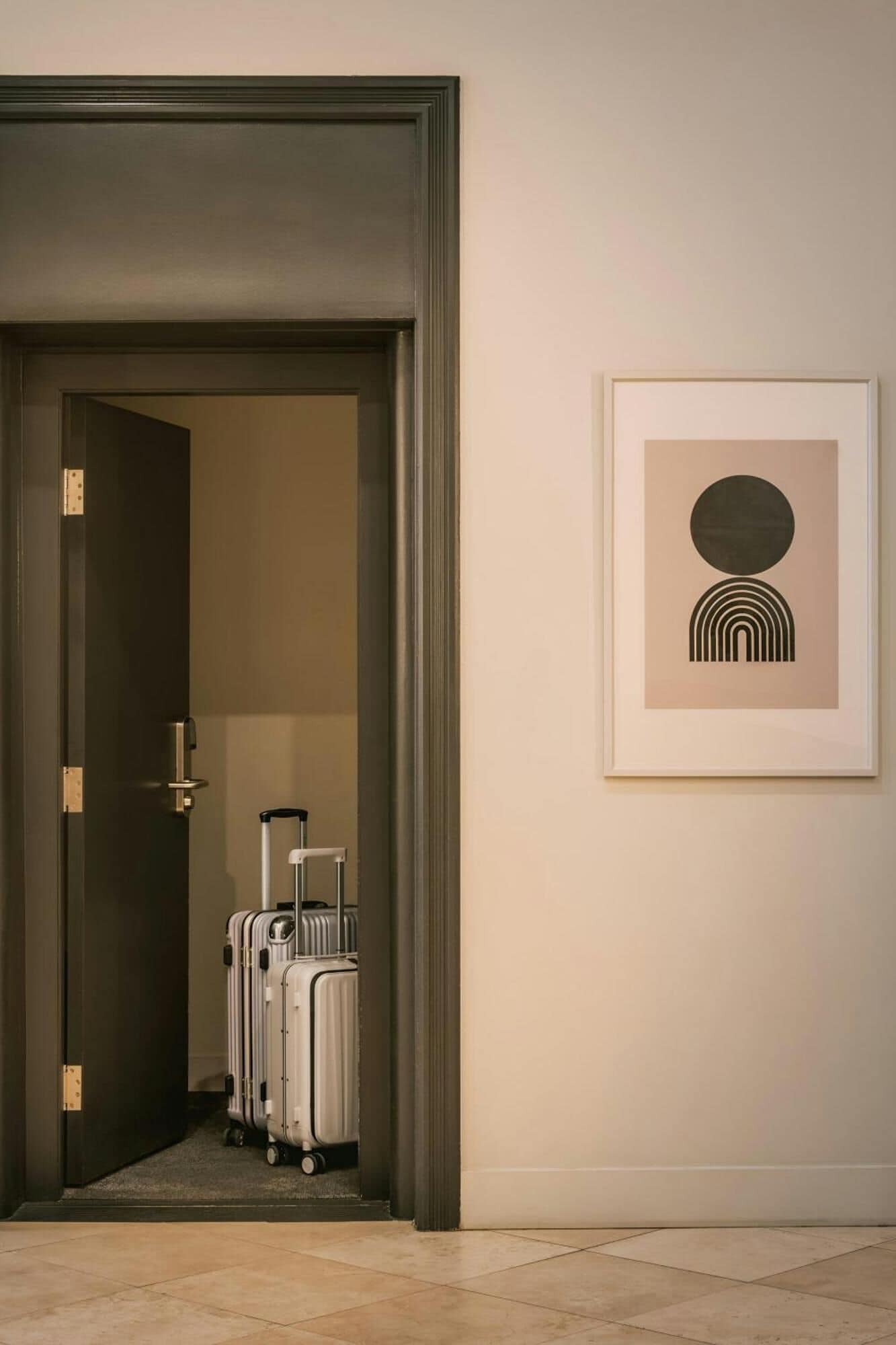 A doorway leading to a room with a framed abstract artwork on the wall.