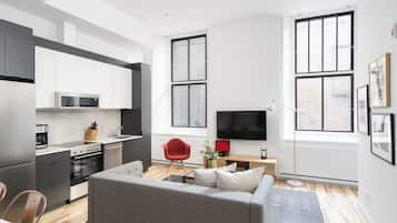 Comfort Apartment | Living area | 65-inch Smart TV with digital channels, Netflix, Hulu