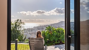 A balcony with a view of a cityscape and hills. - Atlantic Bloom by Homie (Funchal)