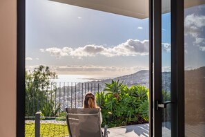 A balcony with a view of a cityscape and hills. - Atlantic Bloom by Homie (Funchal)