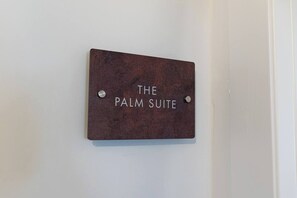 A sign with the text 'THE PALM SUITE' mounted on a wall. - Port city haifa - SeaView 1 bdrm Penthouse (Haifa)