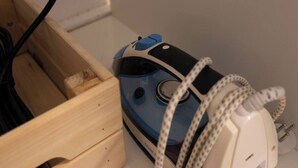 A blue and white electronic device with a cord, placed in a wooden box. - Port city haifa - Studio 217 (Haifa)