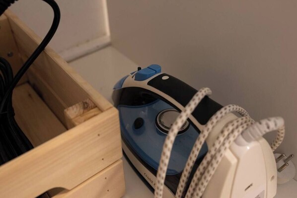 A blue and white electronic device with a cord, placed in a wooden box. - Port city haifa - Studio 217 (Haifa)