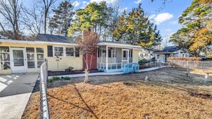 A residential building with a covered porch, a fenced yard, and a small garden area. - Sea Breeze 1019 near Ocean (North Myrtle Beach)