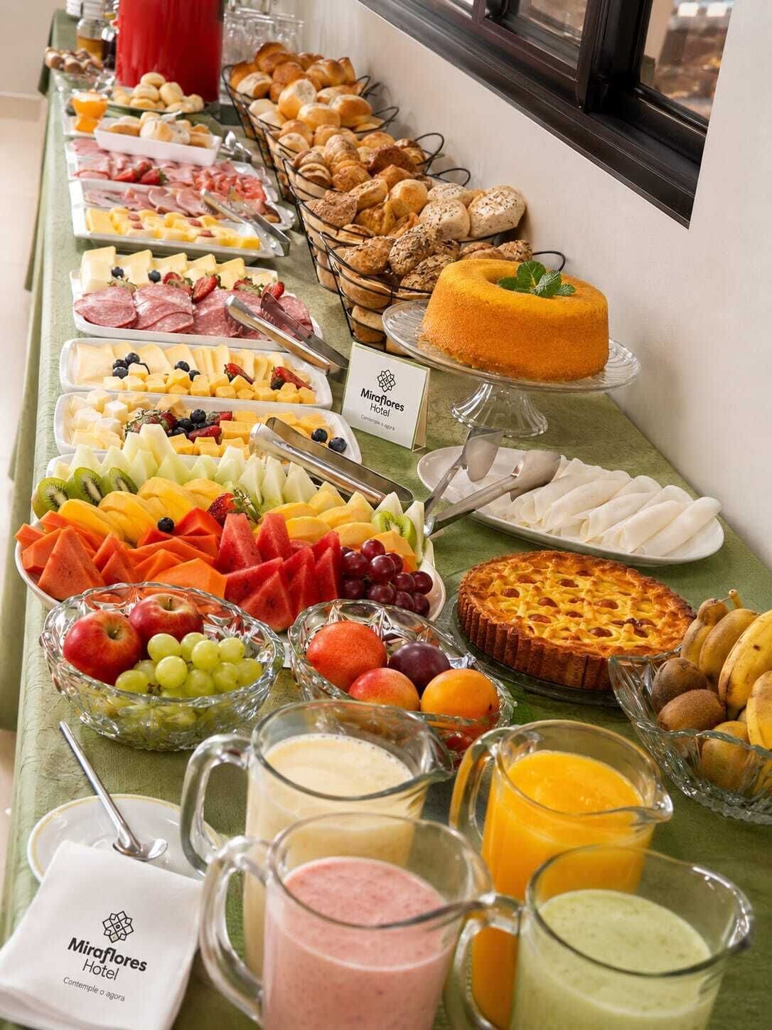 A buffet with various food items and beverages.
