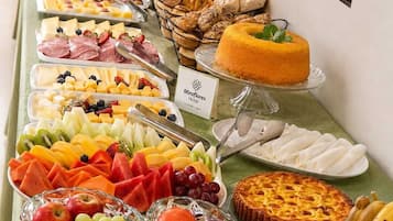 A buffet with various food items and beverages.