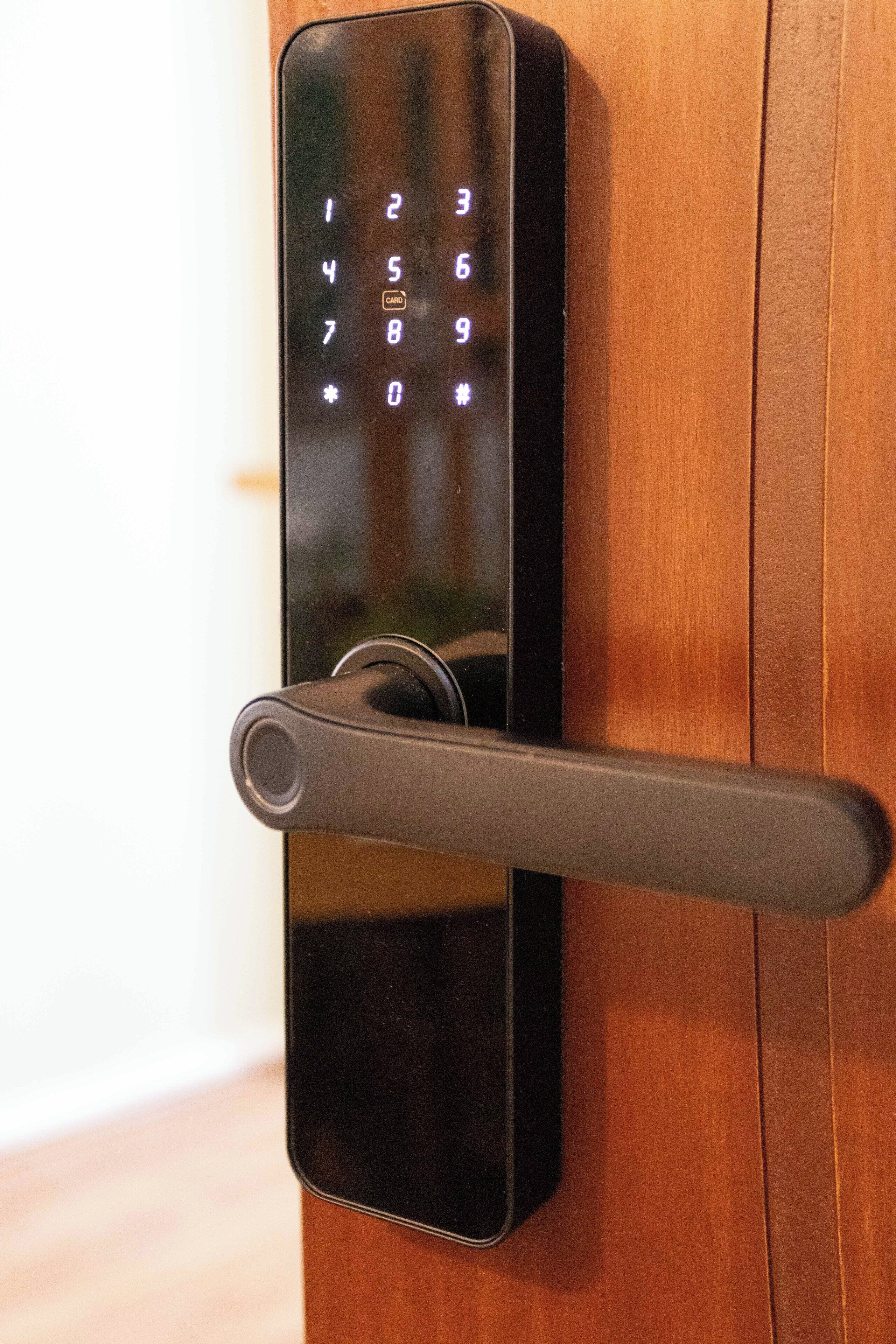 A modern door with a numeric keypad lock and a lever handle.