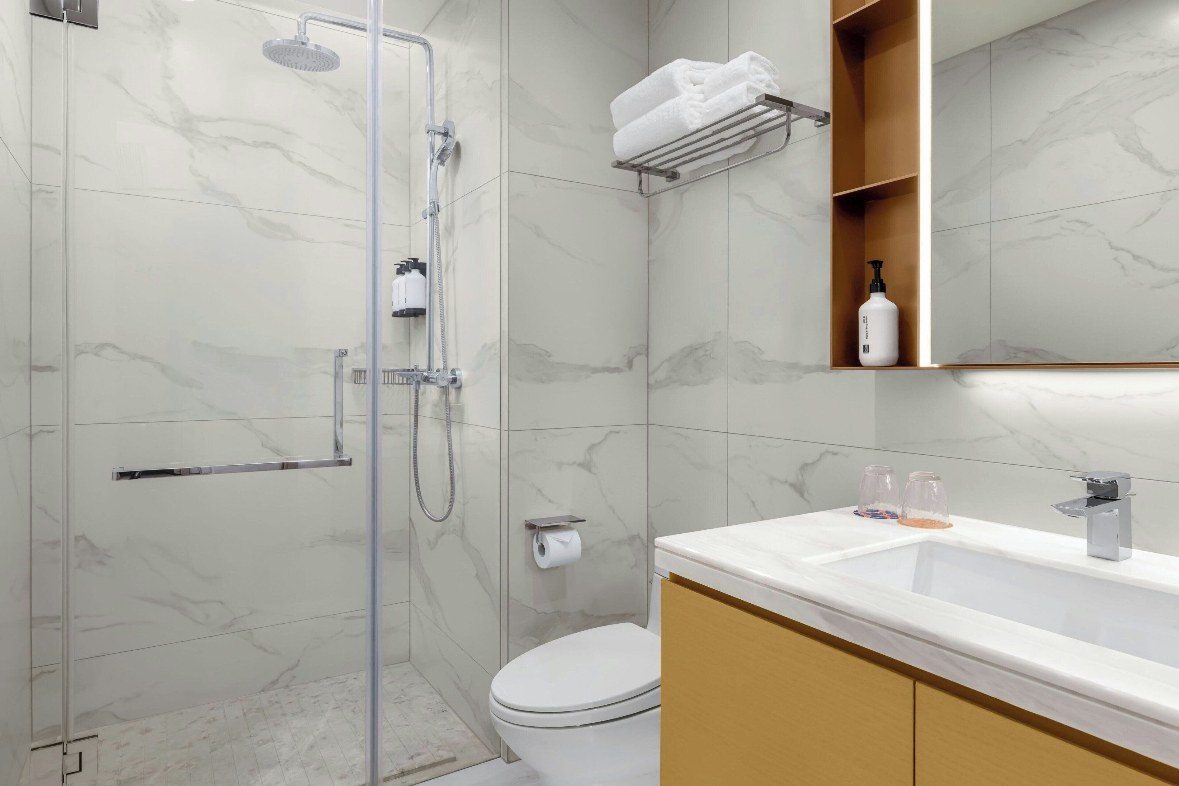 A bathroom with a shower, toilet, and sink.