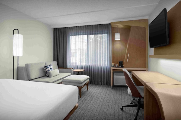 Premium bedding, desk, laptop workspace, blackout drapes