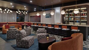 A bar area with seating, a bar counter, and a wall of liquor bottles. - Residence Inn By Marriott Birmingham Grandview (Birmingham)