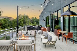 An outdoor seating area with fire pit, chairs, and tables, overlooking a cityscape. - Residence Inn By Marriott Birmingham Grandview (Birmingham)