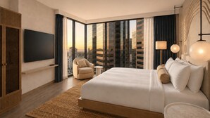A modern hotel room with a large bed, a chair, a TV, and a view of the cityscape. - Denu Hotel & Spa (Phoenix)