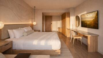 A modern bedroom with a large bed, a desk, and a chair, a large painting on the wall, and a unique textured wall design.